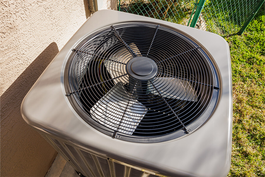 Residential Air Conditioner Condenser Unit outside of a Columbus, Ohio home serviced by Atlas Butler Heating Cooling and Plumbing.