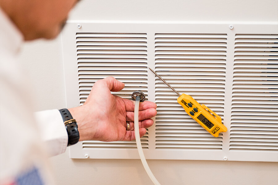 Atlas Butler technician testing the heat differential from a furnace vent at a home in Columbus, Ohio.