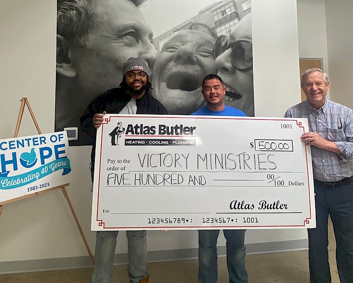 Victory Ministries Food Pantry Center of Hope in Whitehall Ohio being presented with a $500 donation check from Atlas Butler Heating Cooling and Plumbing.