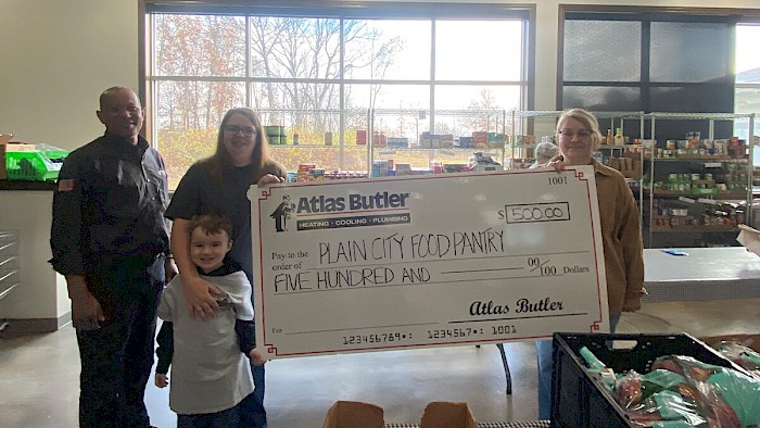 Daily Needs Assistance Center in Plain City Ohio being presented with a $500 donation check from Atlas Butler Heating Cooling and Plumbing.